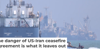 A small motorboat passes anchored vessels in the Strait of Hormuz off Bandar Abbas, Iran, on June 11, 2026. Amirhosein Khorgooi/ISNA via AP